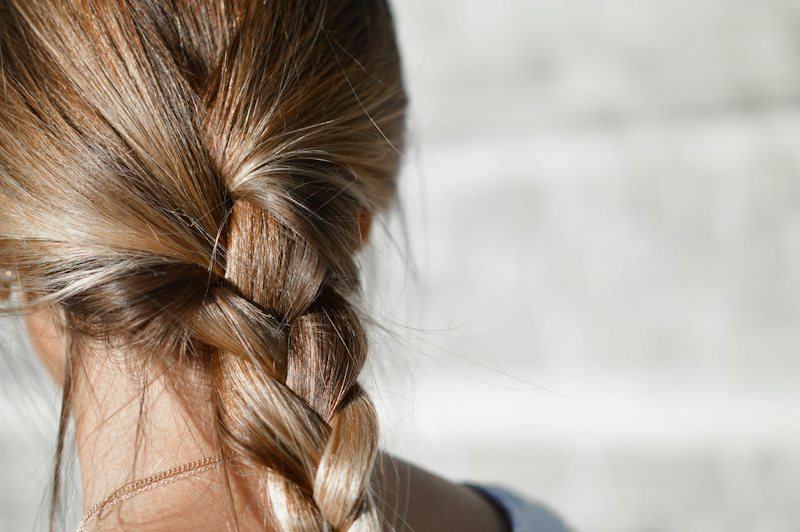 Loose braid in light brown hair, seen from behind